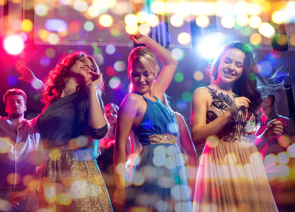 Vibrant concert crowd celebrating under stage bokeh lighting
